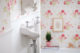 Badrumsinspiration - Liten blommig gästtoalett med pärlspont och turkost golv, gammeldags tvättställ och tavla.
