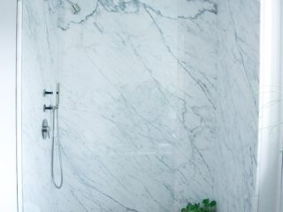 Badrumsinspiration - retro badrum med marmor, mässing och svart tassbadkar i New York 1950tal