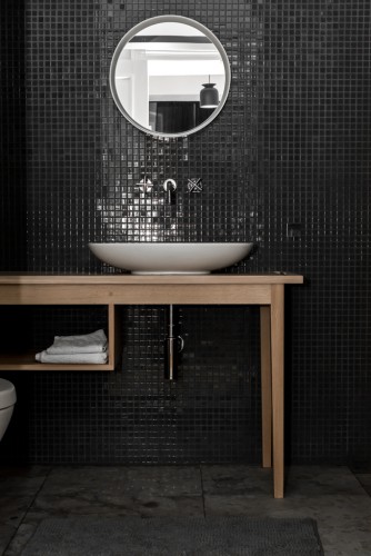 Badrumsinspiration - svart glasmosaik i badrum i Berlin med badrumsmöbel i ek