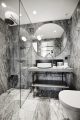 Badrumsinspiration - Grå marmor och rund spegel i badrum på Nobis Hotel Copenhagen ritat av Gert Wingårdh