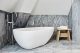 Badrumsinspiration - Grå marmor, äggformat badkar och japanskt badpall i badrum på Nobis Hotel Copenhagen penthouse ritat av Gert Wingårdh