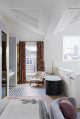 Feature, Notting Hill town house, contemporary, modern, graphic, geometric patterns, family home, bright, interior, open-plan main bedroom, bathroom, free-standing bath, chair, tiles