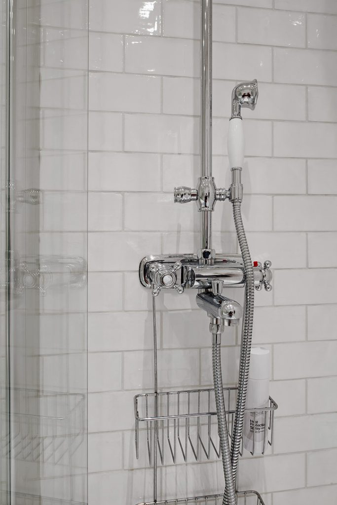 Badrumsinspiration - badrum med inbyggda rör och badkarsblandare med täckbricka.